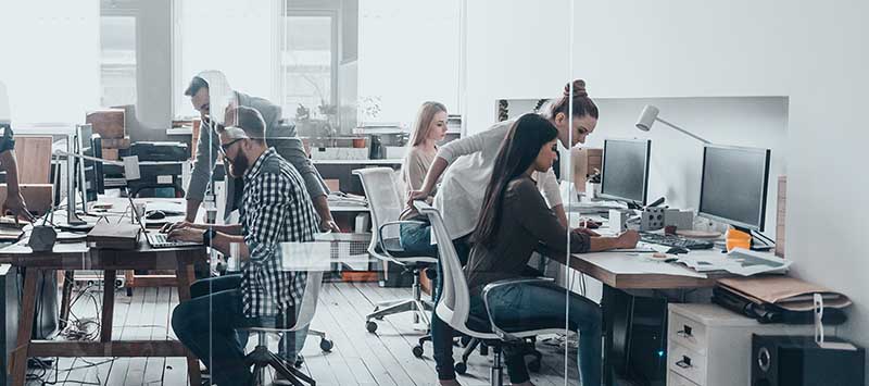 Successful team. Group of young business people working and communicating together in creative office